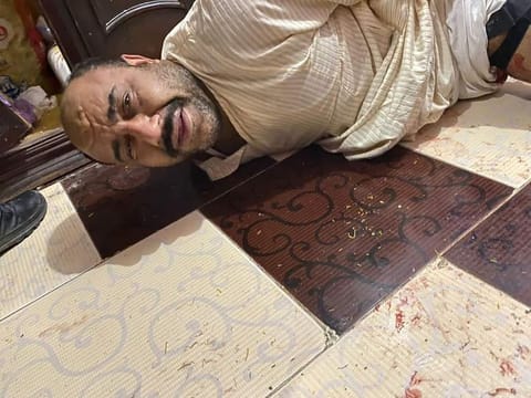 The man, accused of taking his family hostage, being arrested in his home in Fayyoum.
