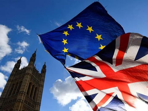 British and EU flags flutter outside the Houses of Parliament in London, Britain