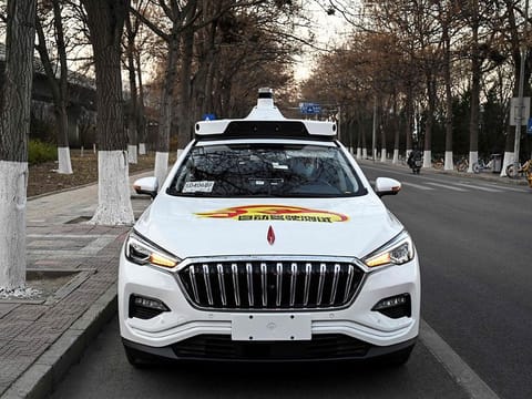 An Apollo Go autonomous taxi on a street in Yizhuang, a town of Daxing District, in the southeast suburbs of Beijing.