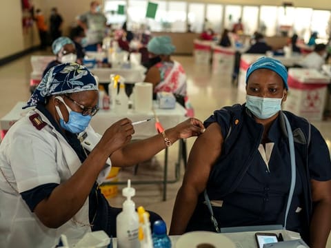 A health care worker is given the Johnson & Johnson COVID-19 vaccine at an assembly hall on the grounds of Charlotte Maxeke Johannesburg Academic Hospital in Johannesburg, South Africa, March 5, 2021.