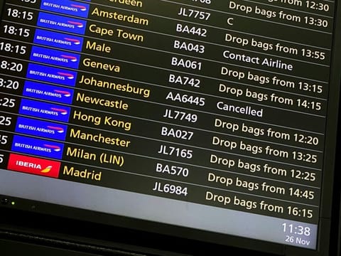 A departures screen displays two cancelled flight to Johannesburg and Cape Tow at Heathrow Airport, in London, November 26, 2021.