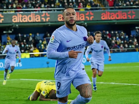 Barcelona's Memphis Depay celebrates after scoring his side's second goal during the La Liga match against Villarreal in Villarreal, Spain.