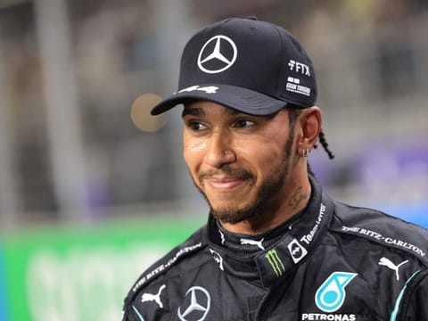 Mercedes' British driver Lewis Hamilton reacts in the parc ferme after taking pole position in the qualifying session of the Formula One Saudi Arabian Grand Prix at the Jeddah Corniche Circuit in Jeddah.