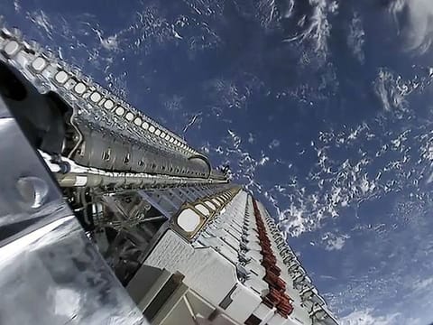 A fleet of SpaceX Starlink internet satellites is seen in this image poised for deployment in orbit from a May 24, 2019 launch.