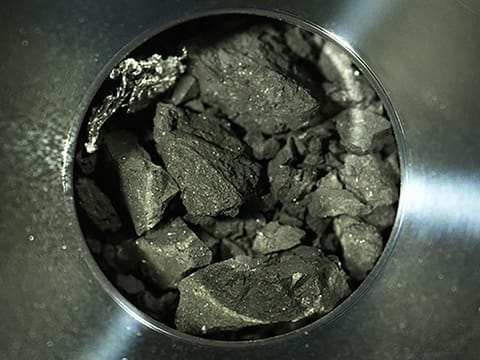 Optical microscope photo provided by the Japan Aerospace Exploration Agency (JAXA) shows soil samples, seen inside C compartment of the capsule brought back by Hayabusa2, in Sagamihara, near Tokyo.