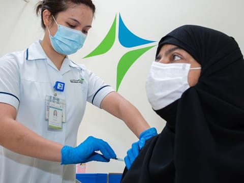 A DHA staff administers a COVID-19 vaccine. Picture for illustrative purposes only.