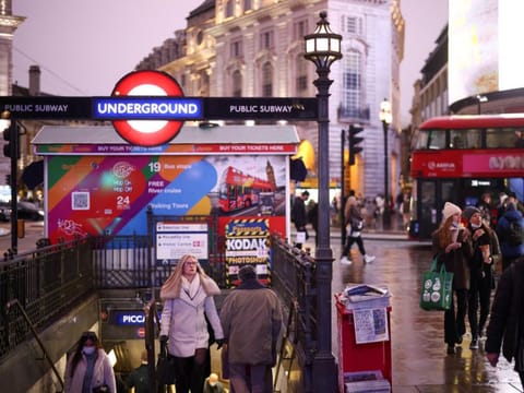 People exit Piccadilly Circus underground station, amid the coronavirus disease (COVID-19) outbreak, in central London, Britain, January 6, 2022.