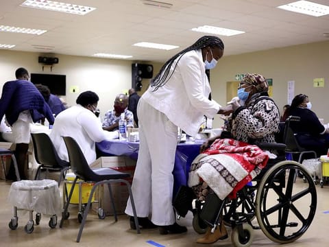 A woman receives a dose of a coronavirus disease (COVID-19) vaccine, as South Africa rolls out the coronavirus disease (COVID-19) vaccination to the elderly at the Munsieville Care for the Aged Centre outside Johannesburg, South Africa May 17, 2021.