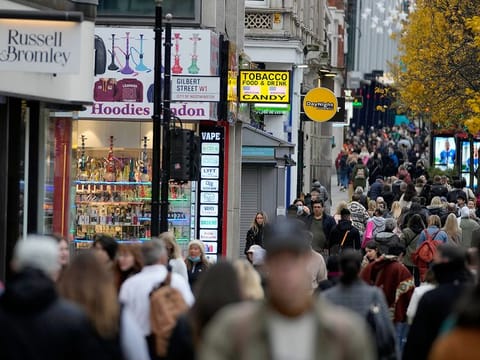 Shoppers walk along Oxford Street, Europe's busiest shopping street, in London.