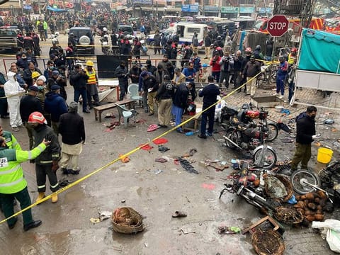 Police officials examine the site of bomb explosion, in Lahore, Pakistan on January 20.