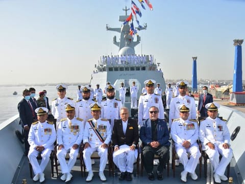 Pakistan's President Dr Arif Alvi with Pakistan Navy officials onboard PNS Tughril during the induction ceremony in Karachi on January 24, 2022.