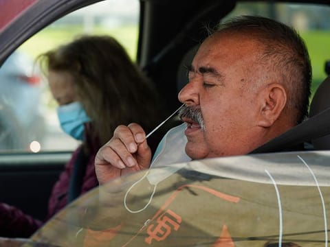 Jose Alfrtedo De la Cruz and his wife, Rogelia, self-test for COVID-19 in Whittier, California.