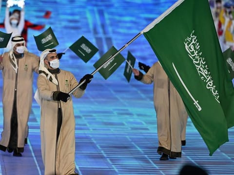 Saudi Arabia's flag bearer Fayik Abdi leads the delegation during the opening ceremony of the Beijing 2022 Winter Olympic Games, at the National Stadium, known as the Bird's Nest, in Beijing.
