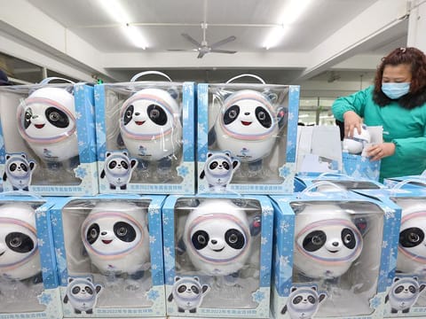 Employees work on the production line for soft toys of Bing Dwen Dwen, the mascot of the Beijing 2022 Winter Olympics, at a licensed manufacturer in Qidong, Jiangsu province, China February 8, 2022.