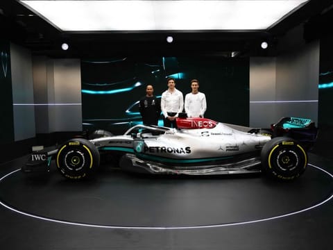 A handout picture released by Mercedes-Benz shows Mercedes drivers Lewis Hamilton (left) and George Russell posing alongside Mercedes chief Toto Wolff (centre) with the new Mercedes-AMG F1 W13 during the launch of the Mercedes car for the 2022 season in Silverstone. Hamilton says he is ready to attack the new Formula One season after getting over a "difficult time" following the traumatic end to his 2021 world championship campaign.