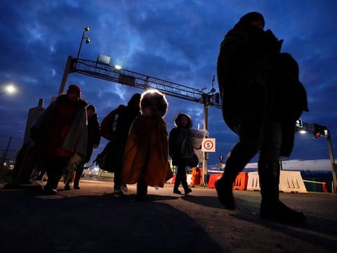 Refugees fleeing conflict in neighboring Ukraine arrive to in Przemysl, Poland. Street fighting broke out in Ukraine's second-largest city Sunday and Russian troops put increasing pressure on strategic ports in the country's south following a wave of attacks on airfields and fuel facilities elsewhere that appeared to mark a new phase of Russia's invasion.
