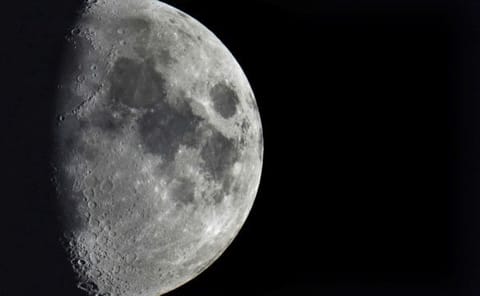 Impact craters cover the surface of the moon, seen from Berlin, Germany, on January 11, 2022. The moon is about to get walloped by 3 tonnes of space junk, a punch that will carve out a crater that could fit several semitractor-trailers.