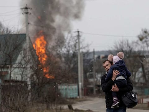Local residents escape from the town of Irpin as Russian troops advance towards the capital of Kyiv, in Irpin, near Kyiv, Ukraine March 6, 2022.
