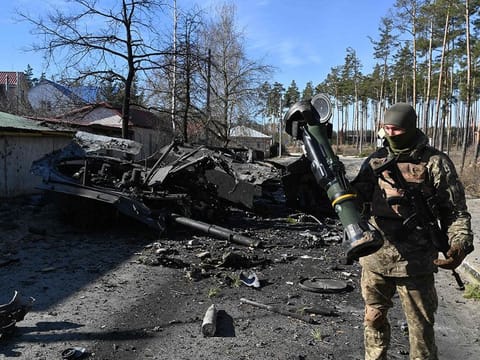 A Ukrainian soldier holds a Next Generation Light Anti-tank Weapon (NLAW) that was used to destroy a Russian armoured personal carrier (APC) in Irpin, north of Kyiv, on March 12, 2022.