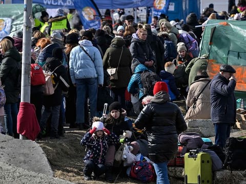 Refugees wait for further transport at the Medyka border crossing at the Polish-Ukrainian border, southeastern Poland on March 12, 2022.