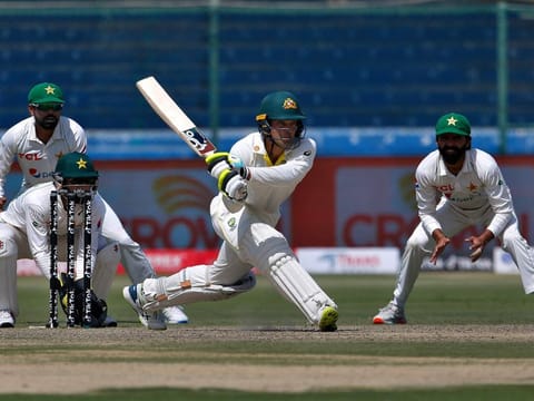 Australia’s Alex Carey plays a shot as Pakistani players watch during the second day of the second Test match at the National Stadium, in Karachi, Pakistan.