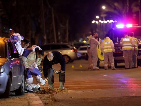 Israeli security forces gather at the site of an attack that left two Israeli police dead in the northern city of Hadera on March 27, 2022.