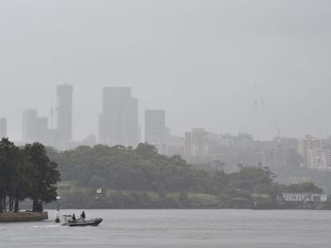 A police boat patrols in the Sydney Harbour during rainfall in Sydney on April 7, 2022, as inclement weather triggered evacuation orders in several suburbs of Sydney's south and southwest.