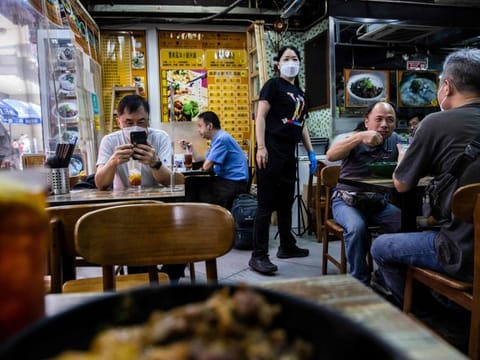 Customers dine at a restaurant in Hong Kong on April 14, 2022, as the Hong Kong government annouces the easing of strict Covid-19 restrictions on April 21.