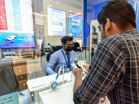 Customers at Lulu Exchange in Sharjah. Is it time to remit money back home again?