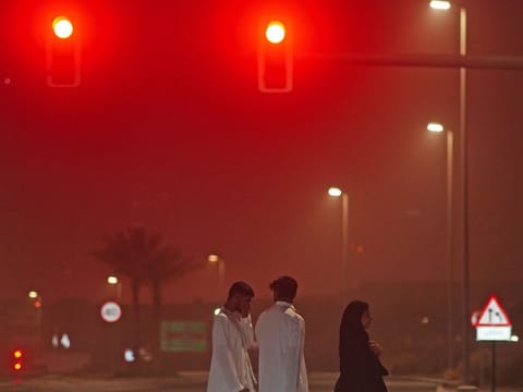 People cover their faces during a sandstorm in Dubai on Tuesday