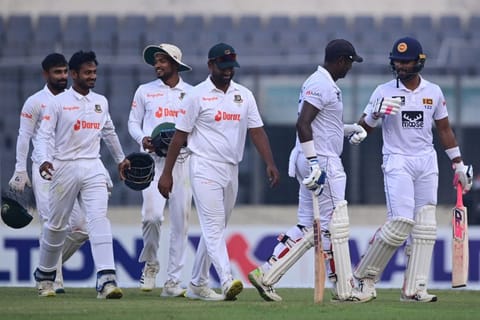 Sri Lanka's Dinesh Chandimal (right) and Angelo Mathews along with Bangladesh's players walk back to the pavilion at the end of the third day of the second Test.