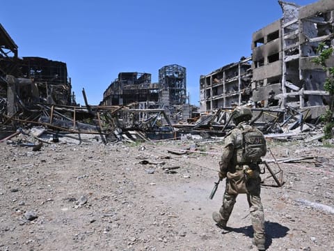 Russian serviceman patrols near the Azovstal steel plant in Mariupol, amid the ongoing Russian military action in Ukraine, on June 13, 2022.