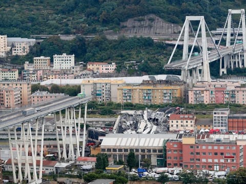 In this Tuesday, Aug. 14, 2018 file photo cars are blocked on the Morandi highway bridge after a section of it collapsed, in Genoa, northern Italy.