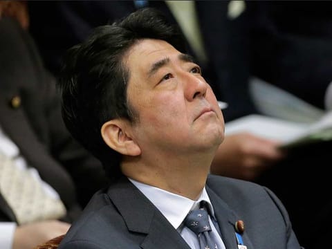 Then Japanese Prime Minister Shinzo Abe listens to a question during a budget committee meeting at Parliament in Tokyo, Tuesday, Feb. 26, 2013.