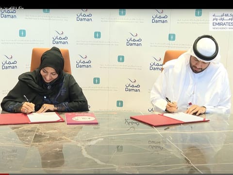 Screengrab from WAM video showing Sarah Shuhail (L), director-general of Ewaa, and Daman CEO Hamad Al Mehyas (R) signing the MoU