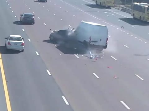 Still from police video showing a van crashing into car that was stopped in the middle of the road
