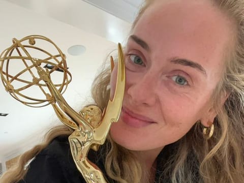 Adele poses with her Emmy award