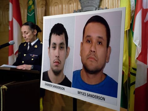 Assistant Commissioner Rhonda Blackmore speaks next to images of Damien Sanderson and Myles Sanderson during a press conference at the Royal Canadian Mounted Police "F" Division headquarters in Regina, Saskatchewan, on Sunday, Sept. 4, 2022.
