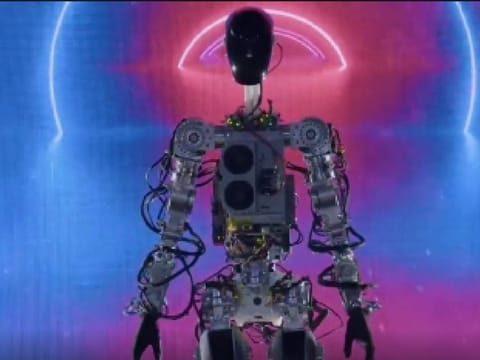 At Tesla's AI Day late Friday, Musk also showed a video of the robot picking up boxes and moving through a rendered office building to water plants.