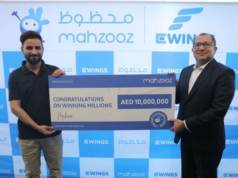 Saad, 32, left, receiving the cheque from Farid Samji, CEO of Ewings.
