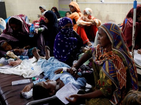 Women sit with their children suffering from malaria and fever, as they receive medical assistance at Sayed Abdullah Shah Institute of Medical Sciences in Sehwan. The UN has sounded alarms about the potential for a second crisis of waterborne and other diseases amid the inundation, which damaged many of Pakistan’s health facilities.