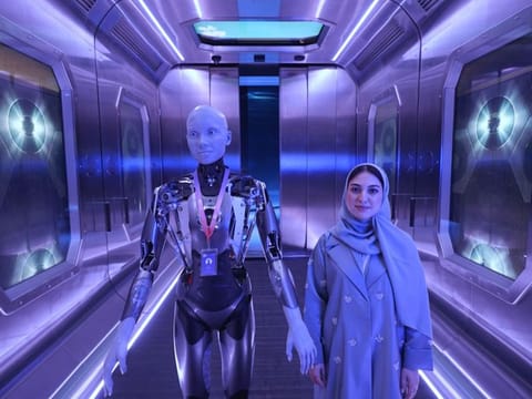 Ameca, the humanoid, in action at the Museum of the Future. She features a human-like face and body.