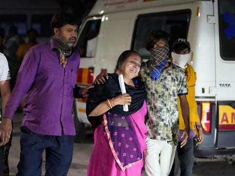 Relatives of a victim mourn after a cable bridge across the Machchu river collapsed in Morbi town of western state Gujarat, India, Monday, Oct. 31, 2022.