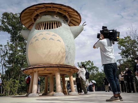 A member of the media taking video of an exhibit of Ghibli character 'Totoro' at Dondoko Forest during a media tour of the new Ghibli Park in Nagakute, Aichi prefecture.