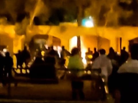 This image grab from a UGC video posted on November 17, 2022, reportedly shows Iranian protesters starting a fire at the family home of the founder of the Islamic republic Ayatollah Ruhollah Khomeini, now a museum, in the central Iranian city of Khomein.