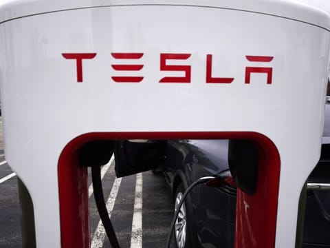 FILE - Tesla Supercharger is seen at Willow Festival shopping plaza parking lot in Northbrook, Ill., on May 5, 2022. New electric vehicle models from multiple automakers are starting to chip away at Tesla's dominance of the U.S. EV market, according to national vehicle registration data. (AP Photo/Nam Y. Huh, File)
