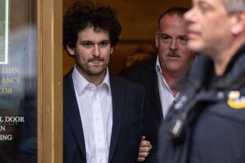 FTX founder Sam Bankman-Fried leaves court following his extradition to the U.S., Thursday Dec. 22, 2022, in New York. Bankman-Fried's parents agreed to sign a $250 million bond and keep him at their California home while he awaits trial on charges that he swindled investors and looted customer deposits on his FTX trading platform. (AP Photo/Yuki Iwamura)