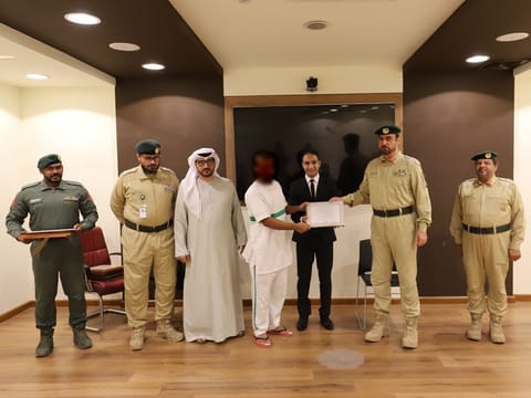 An inmate receives his credentials after passing the course