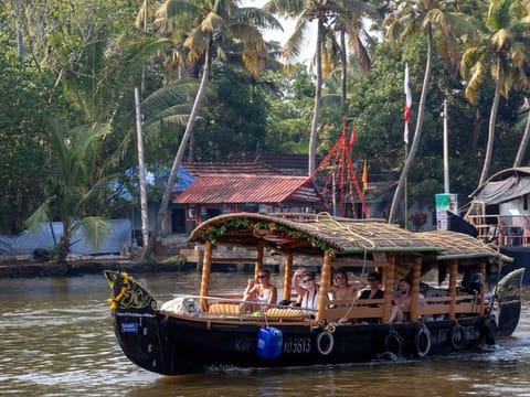 A small traditional Indian boat takes a group of young western tourists on a cruise on the Alleppey backwaters in the southern state of Kerala.