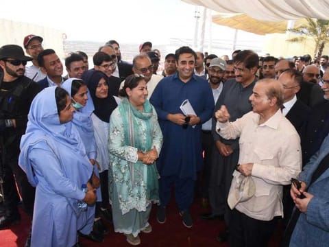 Prime Minister Shehbaz Sharif and Foreign Minister Bilawal Bhutto Zardari interact with local Thari women who work at Thar coal mine during a visit to the area in October 2022.